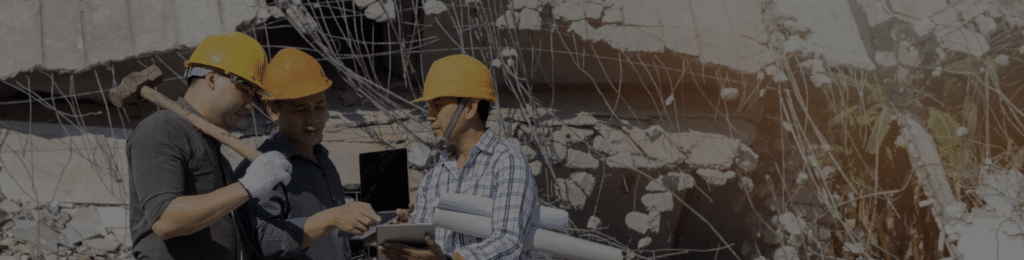 Workers discussing plans at site.